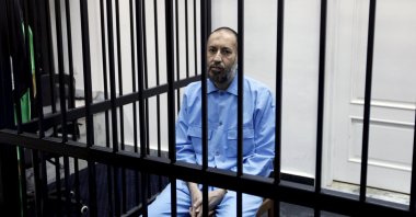 Saadi Gadhafi, son of Moammar Gadhafi, sits behind bars during a hearing at a courtroom in Tripoli, Libya, Feb. 7, 2016. (Reuters Photo)