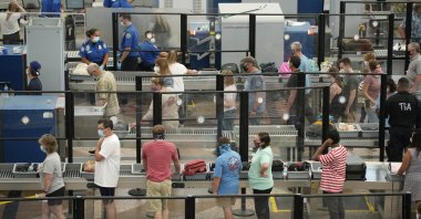Travelers wear face coverings in the queue for the north security checkpoint in the main terminal of Denver International Airport, Colorado, U.S., Aug. 24, 2021. (AP Photo)