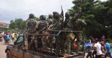 People celebrate in the streets with members of Guinea's armed forces after the arrest of Guinea's president, Alpha Conde, in a coup in Conakry, Guinea, Sept. 5, 2021. (AFP Photo)