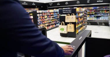 A man uses a QR code on a mobile phone to enter Carrefour's new cashier-less grocery store in Mall of the Emirates in Dubai, United Arab Emirates, Sept. 6, 2021. (AP Photo)