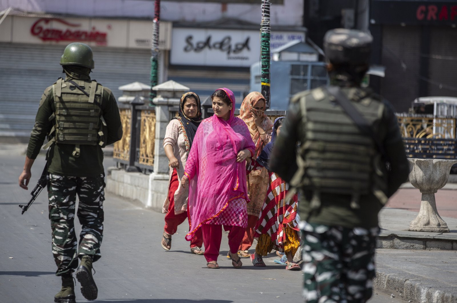 Indian paramilitary soldiers patrol as civilians walk in a deserted market area in Srinagar, Indian-controlled Kashmir, Sept. 2, 2021. (AP Photo)