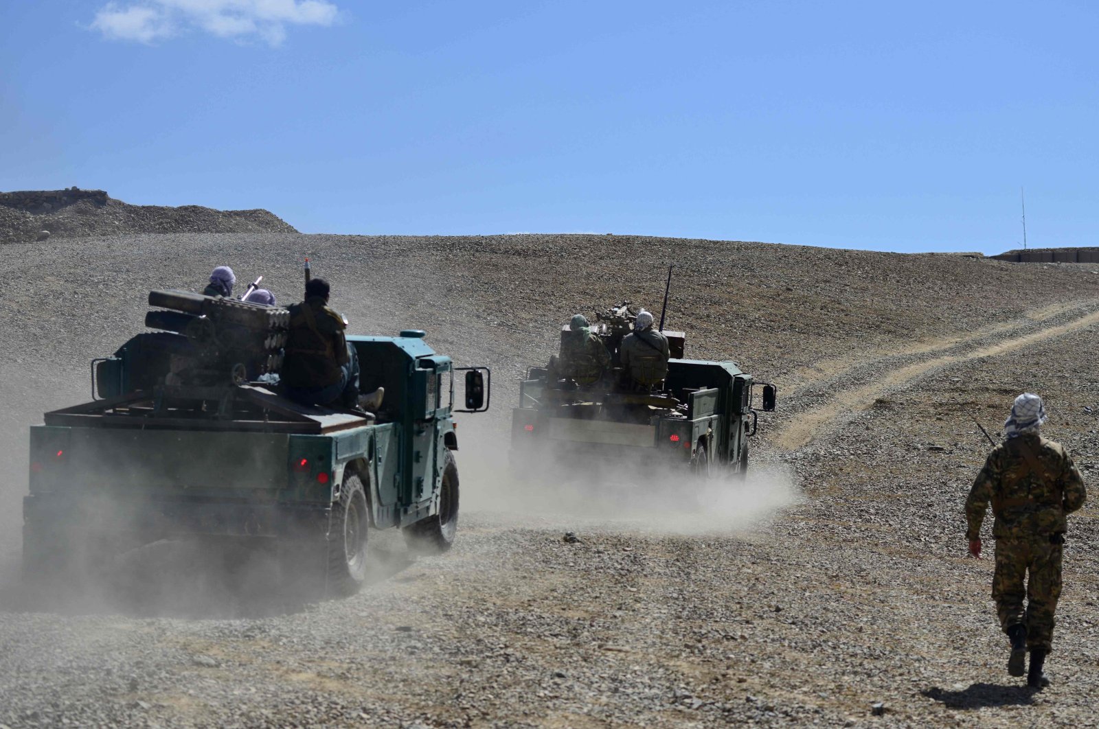 Afghan resistance movement and anti-Taliban uprising forces personnel patrol in armored humvees at an outpost in Kotal-e Anjuman of Paryan district in Panjshir province, Afghanistan, Aug. 23, 2021. (AFP Photo)