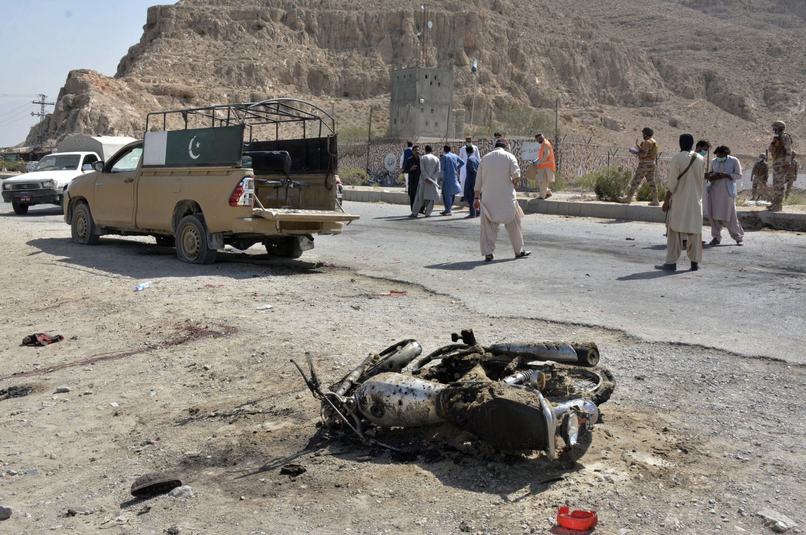 Security officials examine the site of suicide bombing in a checkpoint on the outskirts of Quetta, Pakistan, Sept. 5, 2021. (AP Photo)