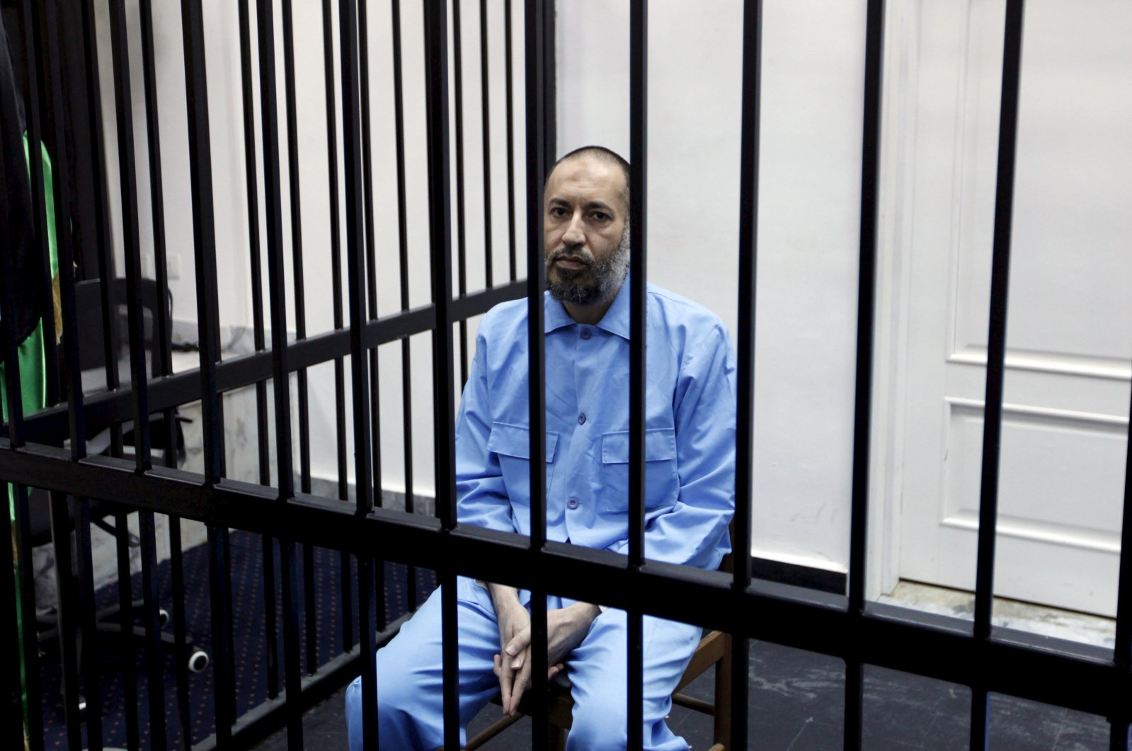 Saadi Gadhafi, son of Moammar Gadhafi, sits behind bars during a hearing at a courtroom in Tripoli, Libya, Feb. 7, 2016. (Reuters Photo)