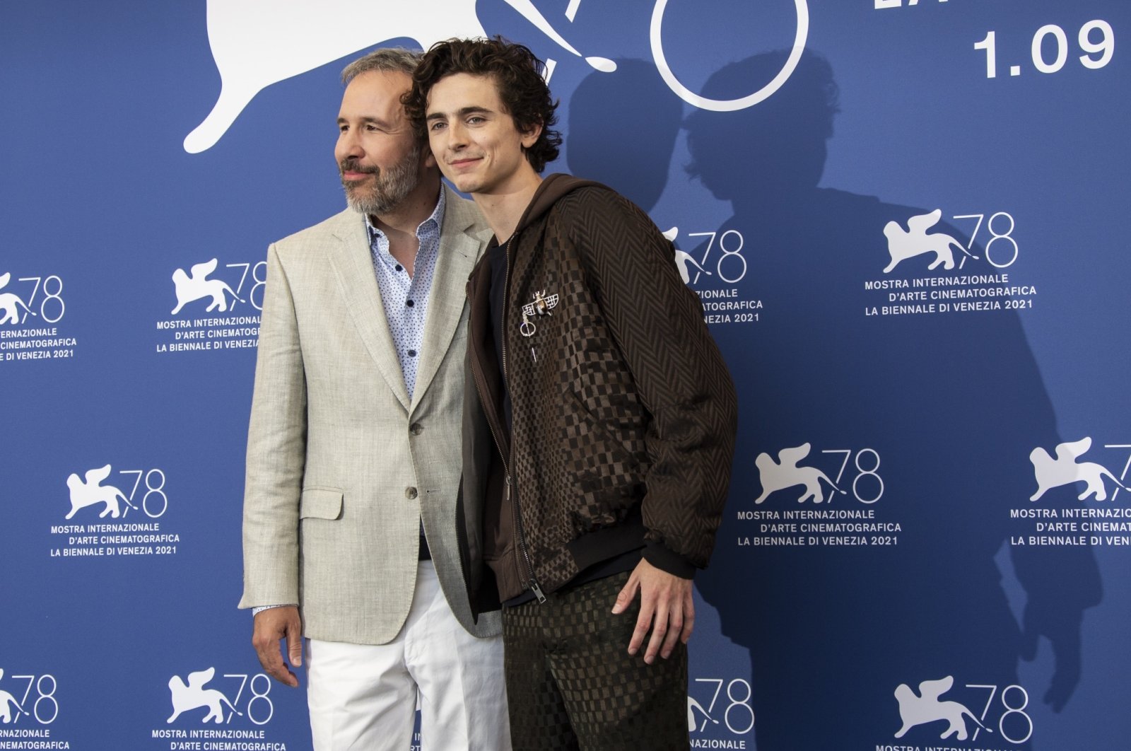 Denis Villeneuve (L), and Timothee Chalamet pose for photographers at the photocell for the film “Dune” at the 78th Venice Film Festival, in Venice, Italy, Sept. 3, 2021. (AP Photo)