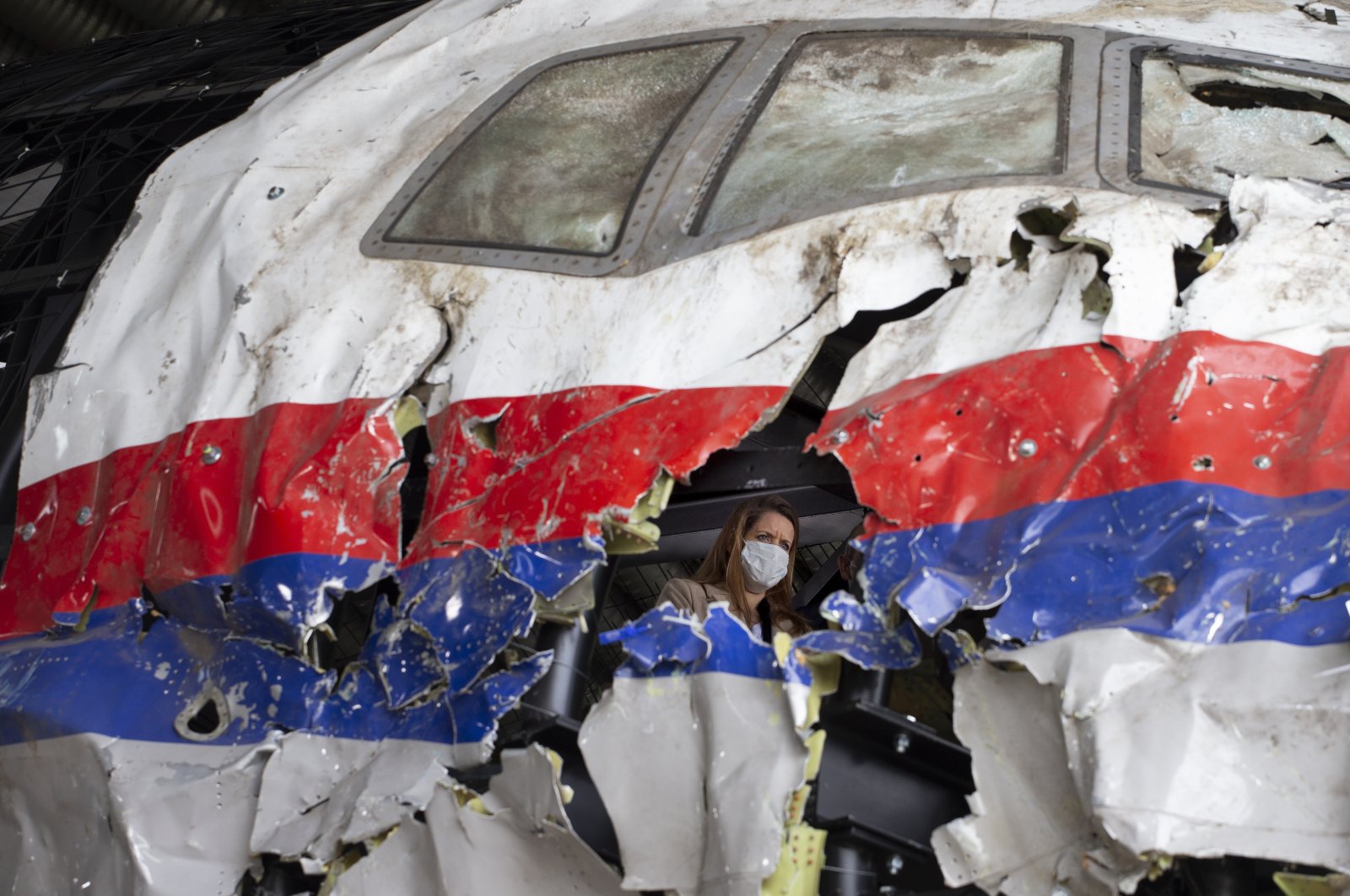 Trial judges and lawyers view the reconstructed wreckage of Malaysia Airlines Flight MH17, at the Gilze-Rijen military air base, southern Netherlands, May 26, 2021. (AP Photo)