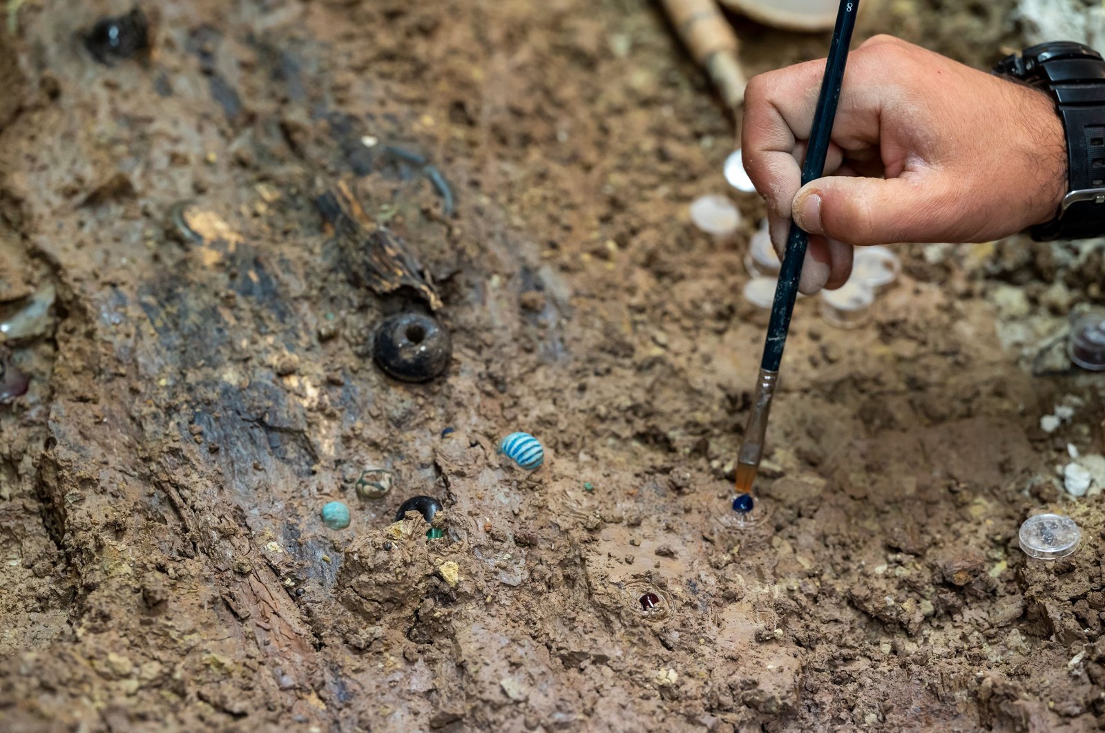 A restorer works at the Rheinisches Landesmuseum on beads made of glass and rock crystal that were recently found during a block salvage near Trier, Germany, June 23, 2021. (Getty Images)