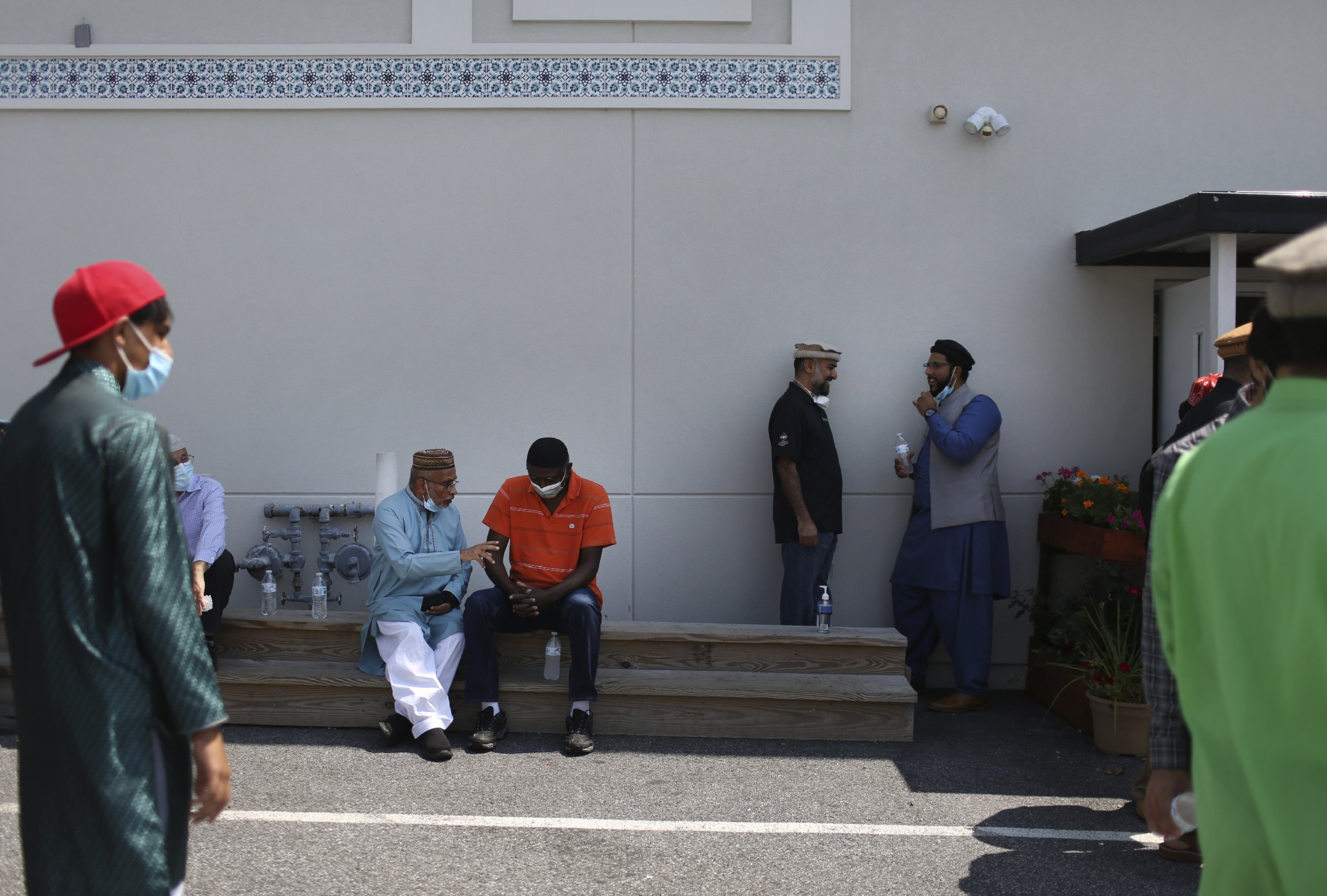 Community members talk outside of their local mosque after Friday prayer, Rosedale, Maryland, U.S., Aug. 13, 2021. (AP Photo)