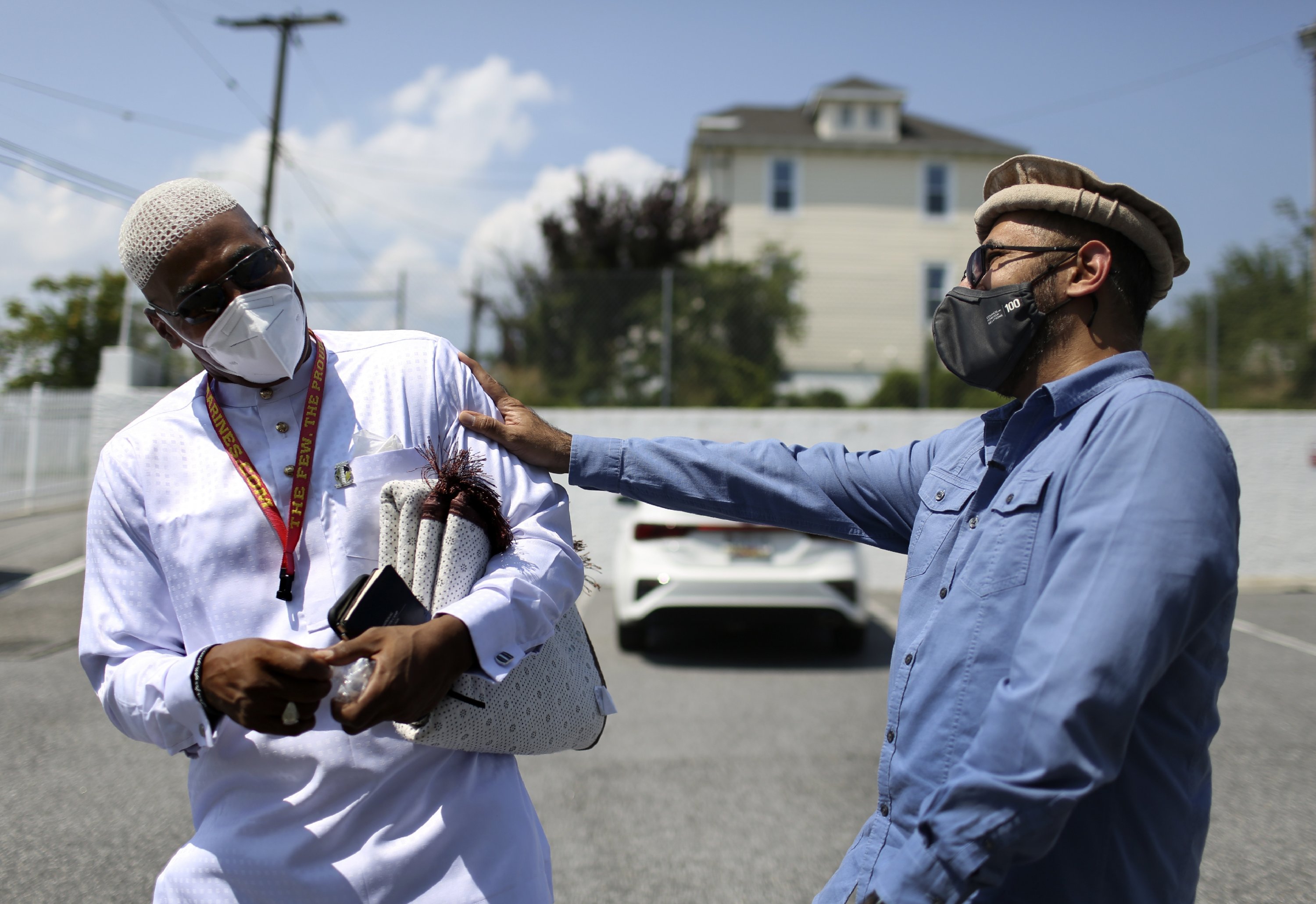 Abdul Latif Balanta (L) and Mansoor Shams joke with each other after Friday prayer, Rosedale, Maryland, U.S., Aug. 13, 2021. (AP Photo)