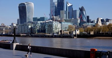 A woman exercises with her dog near the City of London financial district, in London, Britain, April 30, 2021. (Reuters Photo)