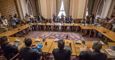 Egypt's Deputy Foreign Minister Hamdi Sanad Loza (background) meets with his Turkish counterpart Sedat Önal (Foreground) in the foreign ministry headquarters in Cairo, Egypt, May 5, 2021. (AFP Photo)