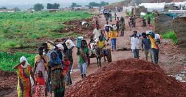 Ethiopian refugees who fled the fighting in the Tigray Region transport jerrycans of water at Umm Rakuba camp in eastern Sudan's Gedaref State, Aug. 11, 2021. (AFP Photo)