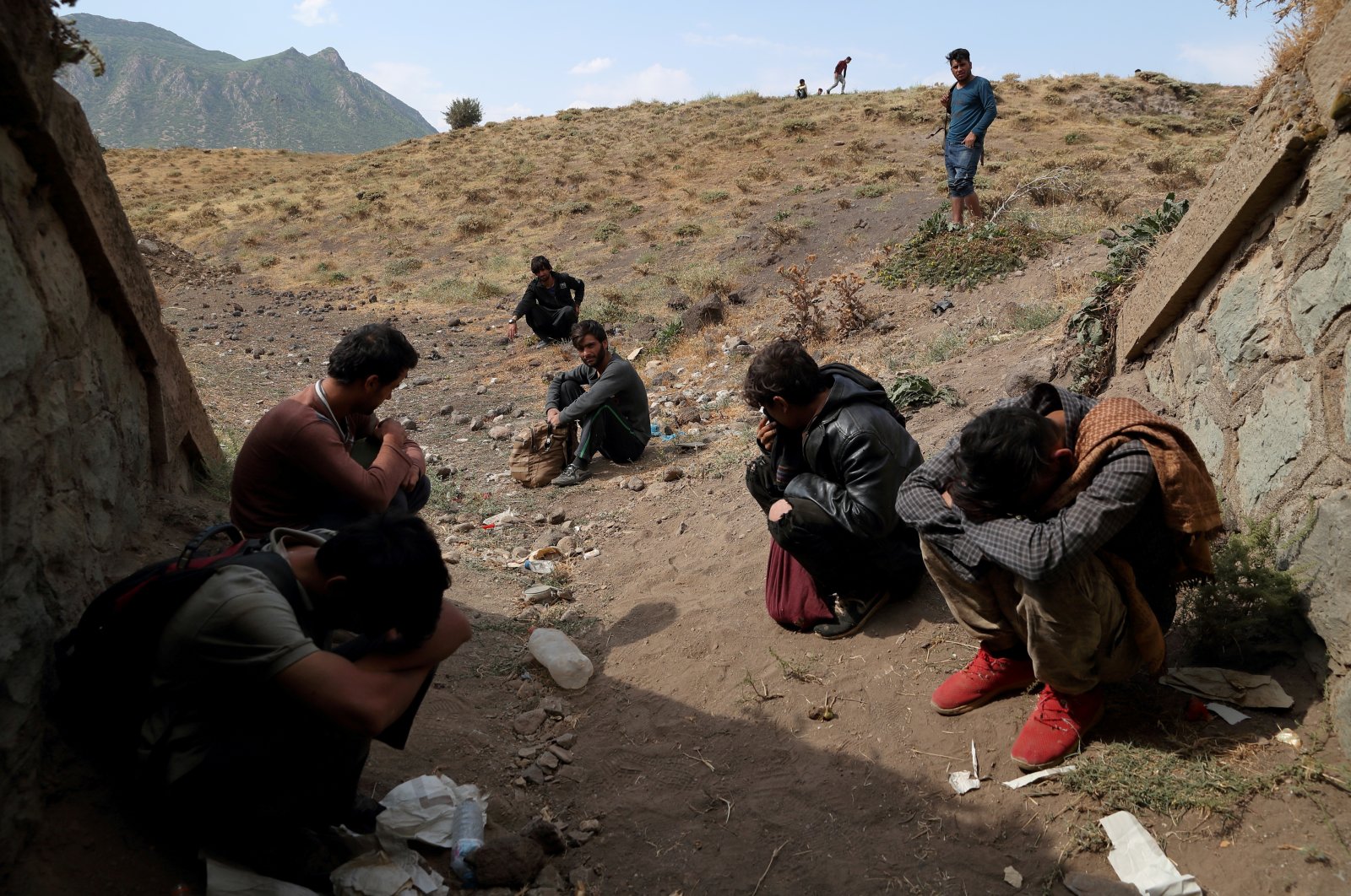 Afghan migrants hide from security forces after crossing illegally into Turkey from Iran, near Tatvan in Bitlis province, Turkey Aug. 23, 2021. (Reuters File Photo)