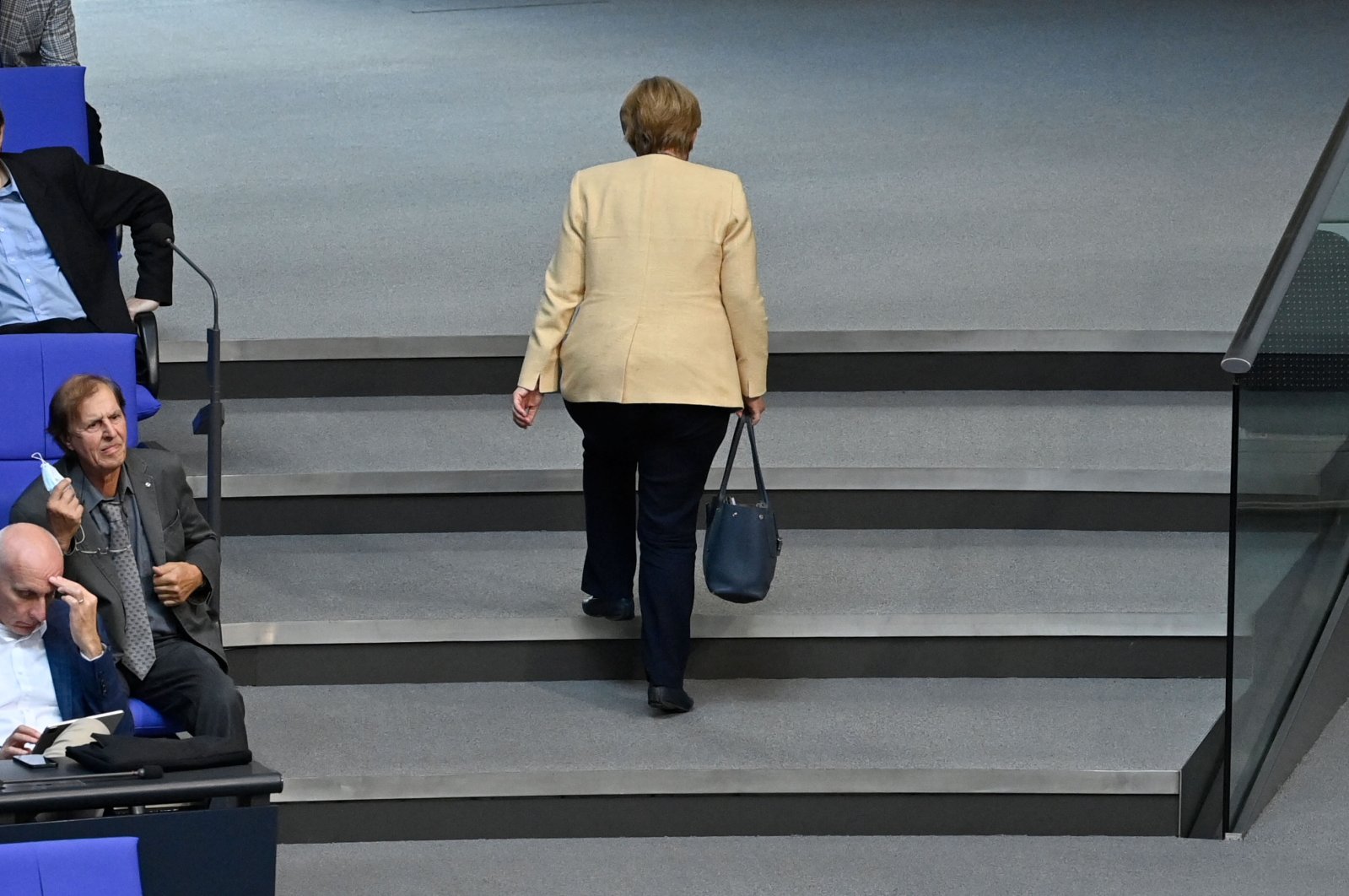 German Chancellor Angela Merkel leaves the plenary hall during a session at the Bundestag, the German lower house of parliament, in Berlin, Germany, Sept. 7, 2021. (AFP Photo )