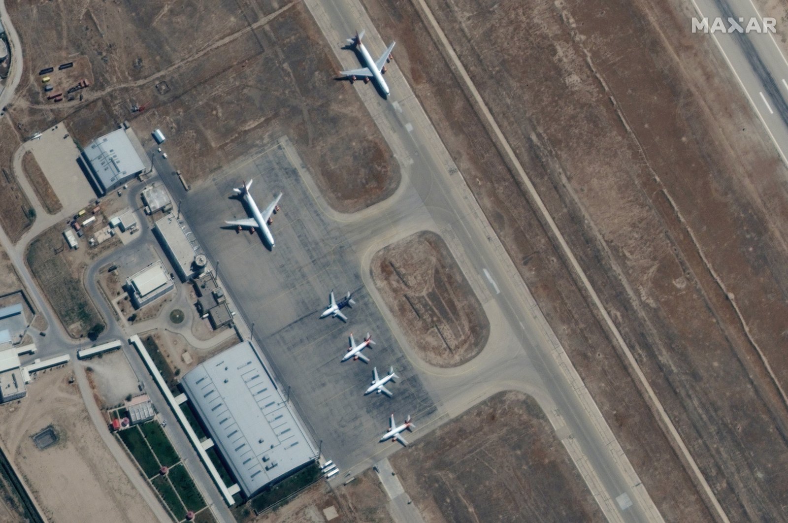 A handout satellite image made available by Maxar Technologies shows airplanes near the main terminal at Mazar-e-Sharif airport, northern Afghanistan, Sept. 3, 2021.