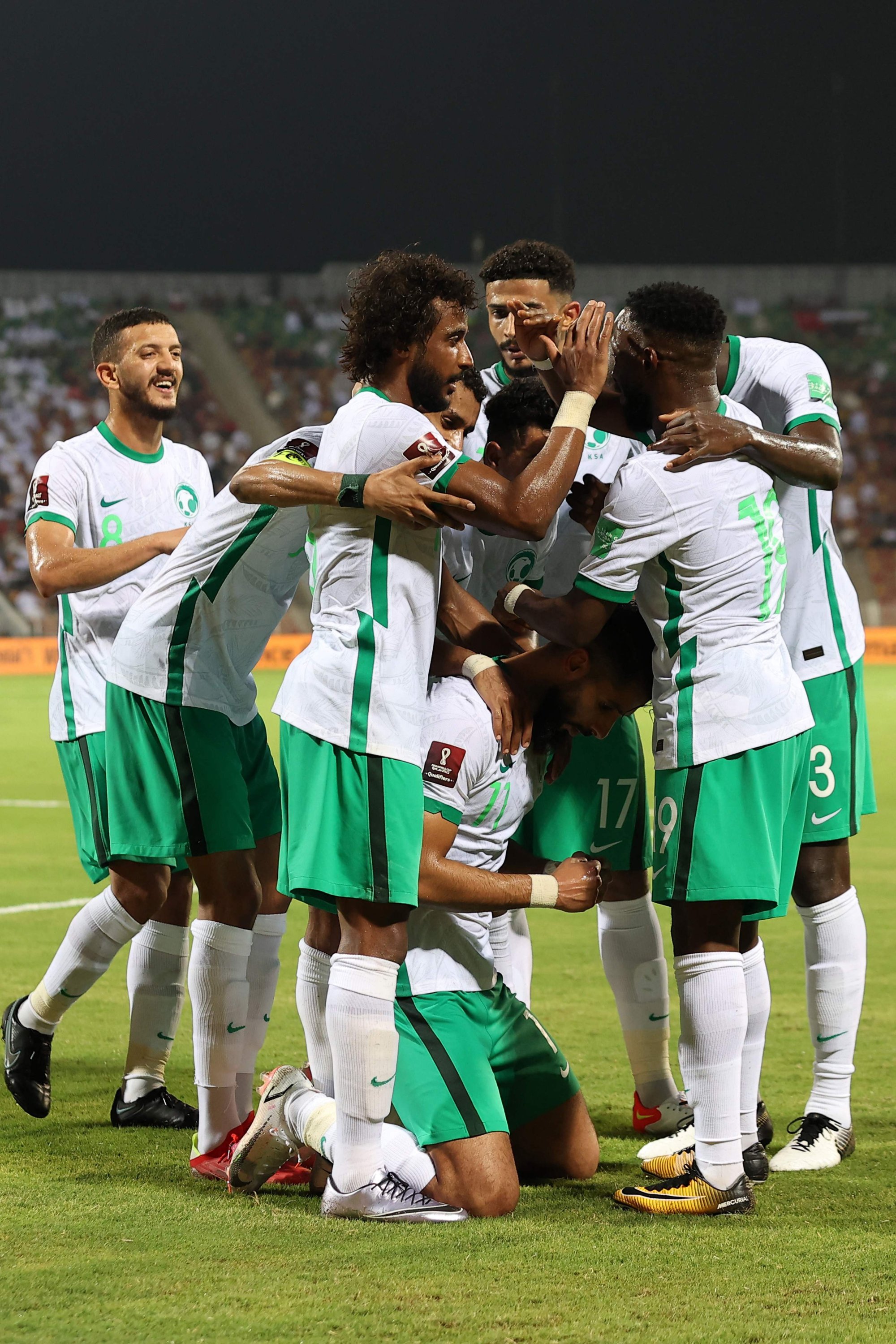 Saudi's players celebrate their opening goal during the 2022 Qatar football World Cup Asian Qualifiers match against Oman at the Sultan Qaboos Stadium in Muscat, Oman, Sept. 7, 2021. (AFP Photo)
