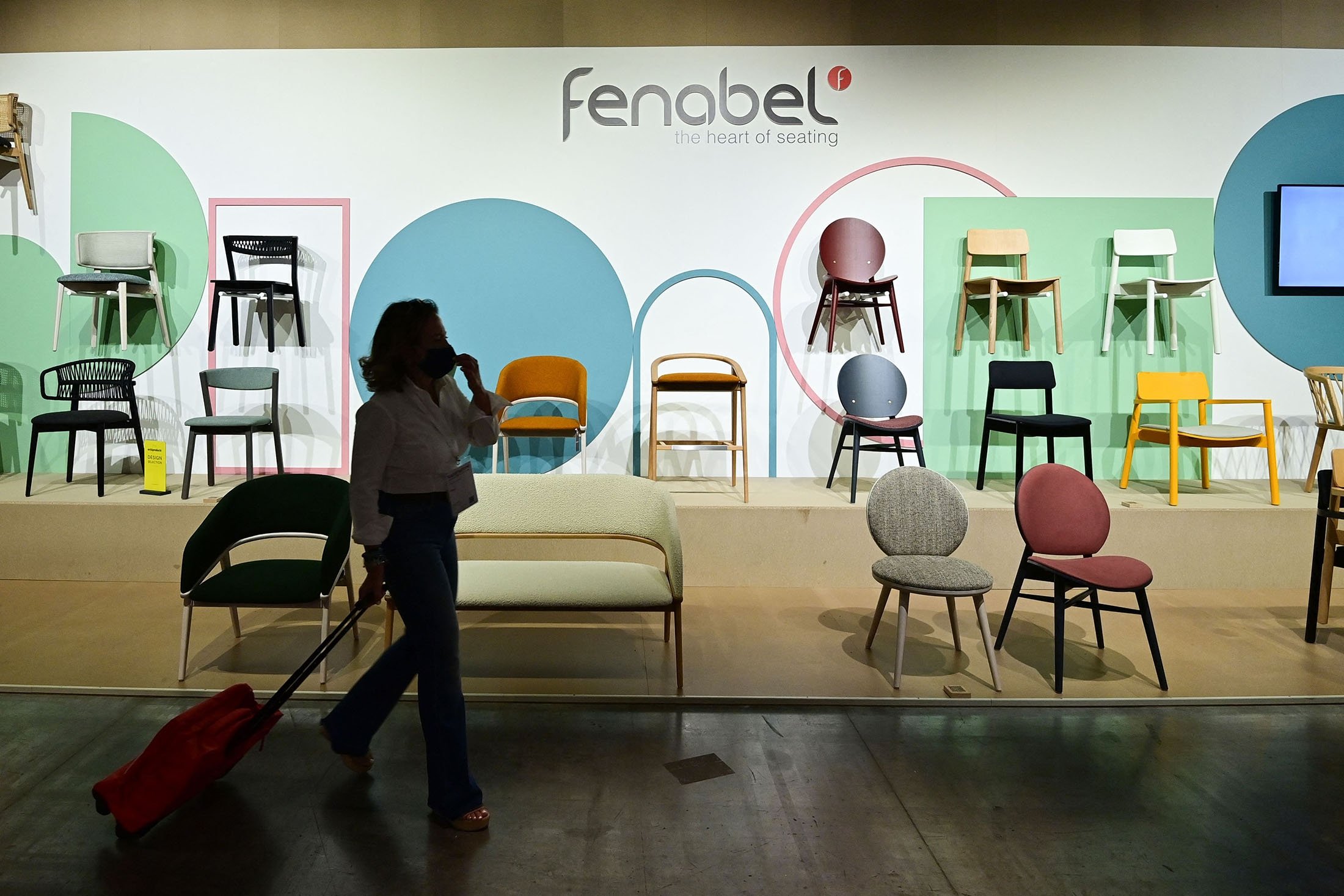 A visitor walks past the Fenobel stand, at the "Super Salone" one of the special event of the 2021 Salone del Mobile Milano, an International Furnishing and Design Fair, in Rho on the outskirts of Milan, northern Italy, Sept. 7, 2021. (AFP Photo)
