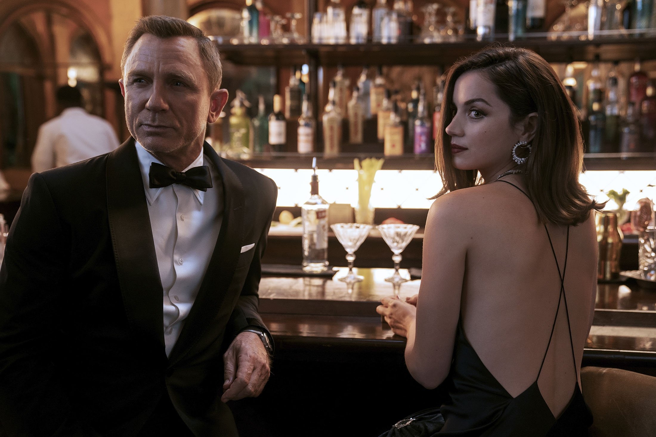 Daniel Craig (L), and Ana de Armas, in a scene from the film "No Time To Die." (MGM via AP)