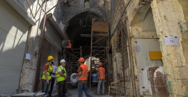 Workers restore historic buildings in the "Souq al-Habil" (ropes market) in the wake of years of conflict, Aleppo, Syria, on Aug. 29, 2021. (AFP Photo)