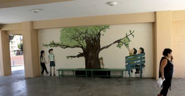 A cleaning woman walks in an empty primary school during a two-day strike by teachers in Nicosia, Greek Cyprus, Sept. 18, 2018. (AP File Photo)