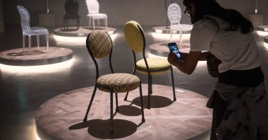 People look at "Monsieur et Madame Dior" by artist Pierre Yovanovitch displayed during the Fuorisalone 2021 design week in Palazzo Citterio, in Milan, Italy, Sept. 4, 2021. (AFP Photo)