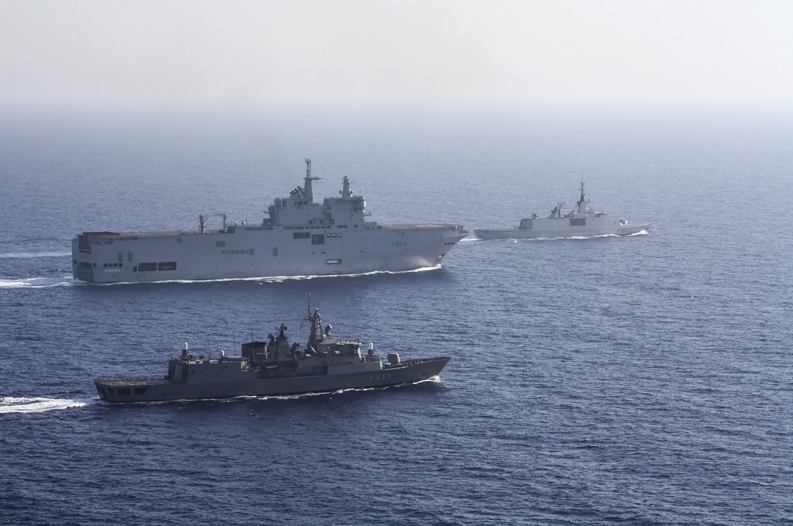 A French Tonnerre helicopter carrier, rear left is escorted by Greek and French military vessels during a maritime exercise in the Eastern Mediterranean, Aug. 13, 2020. (AP Photo)