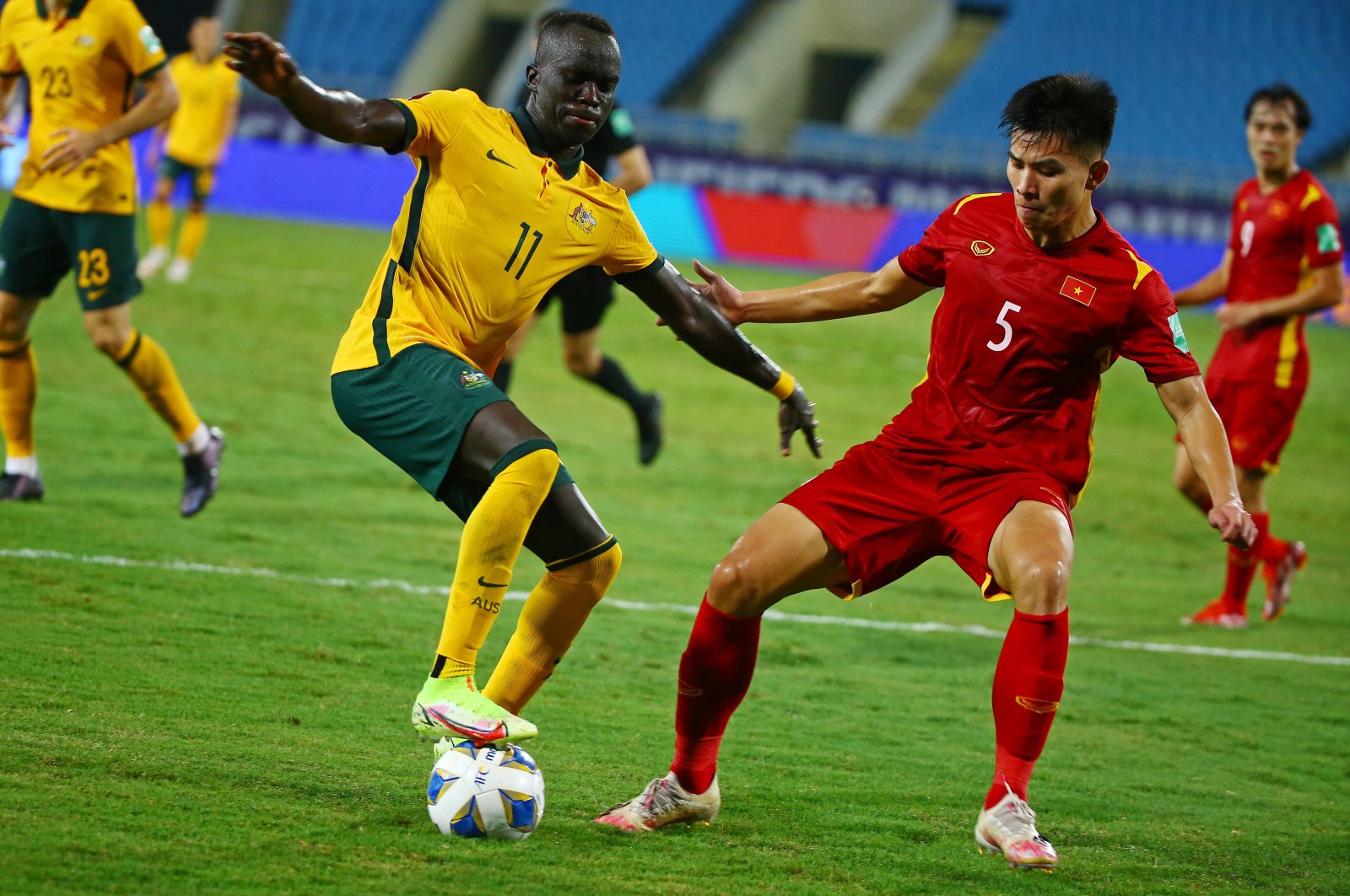 Vietnam's Nguyen Thanh Binh (R) in action against Australia's Awer Mabil (L) during the final round of the 2022 FIFA World Cup Asian qualifiers in Hanoi, Vietnam, Sept. 7, 2021. (EPA Photo)