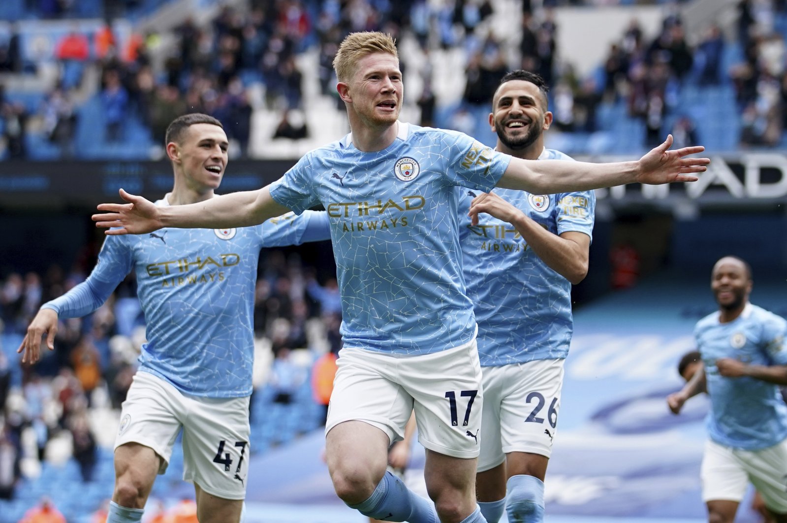 Manchester City's Kevin De Bruyne (C) Phil Foden (L) and Riyad Mahrez celebrate a goal against Everton in the Premier League, Manchester, England, May 23, 2021. (AP Photo)