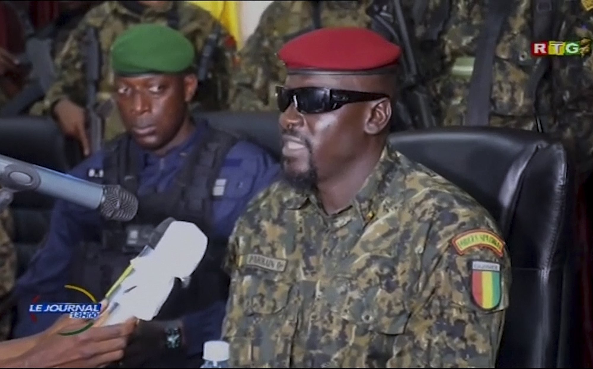 In this image from video, leader of the coup and head of the National Committee for Rally and Development Col. Mamady Doumbouya (C) speaks to members of the armed forces in the capital Conakry, Guinea, Sept. 7, 2021. (AP Photo)