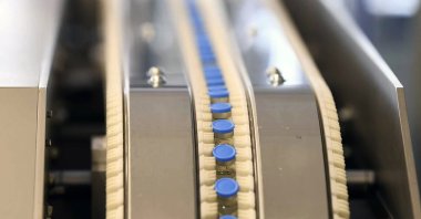 Vials of the Johnson & Johnson vaccine move along a conveyor belt at ASPEN Pharmaceuticals in Port Elizabeth, South Africa, March 29, 2021. (AP Photo)
