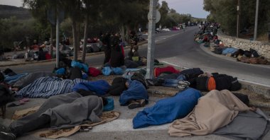 Refugees and migrants sleep on a street near the destroyed Moria camp following a fire, on Lesbos island, Greece, Sept. 10, 2020. (AP Photo)