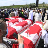 Caskets draped in Canadian flags arrive at a funeral for the four Muslim family members killed in a deadly vehicle attack, at the Islamic Centre of Southwest Ontario in London, Ont., on Saturday, June 12, 2021. (AP File Photo)