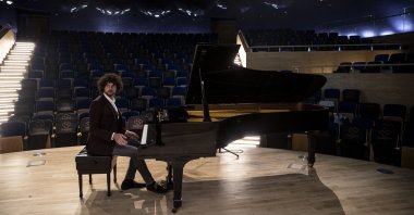 French pianist Simon Ghraichy poses with a piano at the Presidential Symphony Orchestra's concert hall, Ankara, Turkey, Sept. 8, 2021. (AA Photo) 