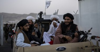 Taliban fighters sit in a pickup truck at the airport in Kabul, Afghanistan, Sept. 9, 2021. (AP Photo)