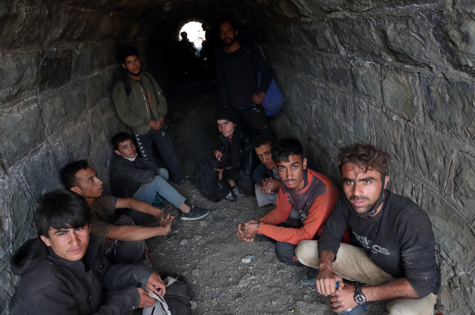 Afghan migrants hide from security forces in a tunnel under train tracks after crossing illegally into Turkey from Iran, near Tatvan in Bitlis province, Turkey, Aug. 23, 2021. (REUTERS Photo)