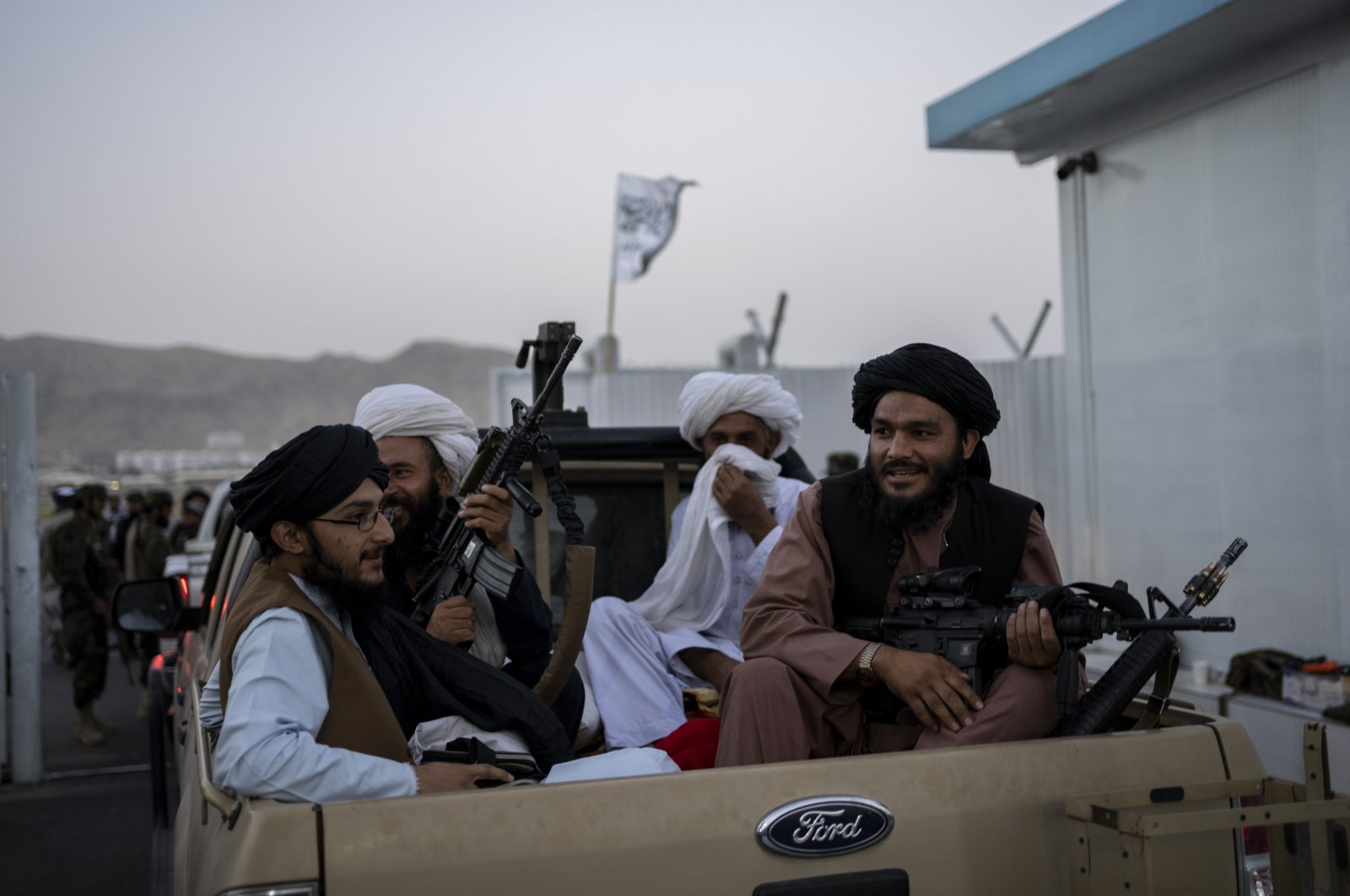 Taliban fighters sit in a pickup truck at the airport in Kabul, Afghanistan, Sept. 9, 2021. (AP Photo)