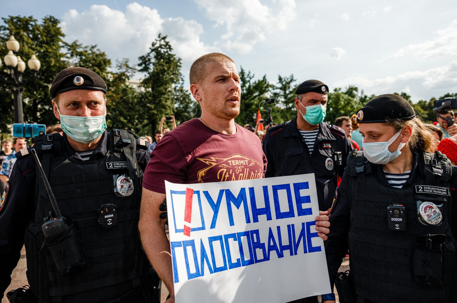 Police officers detain a man with a poster reading "Smart voting" in Moscow, Russia, Aug. 14, 2021. (AFP Photo)