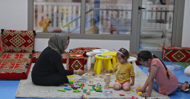 Afghan refugee children play at an indoor space near their accommodation at Park View Villas, a Qatar's 2022 FIFA World Cup residence designated to host the event's organizing committee, transformed into a housing center for Afghan refugees, in Doha, Qatar, Sept. 2, 2021. (AFP Photo)