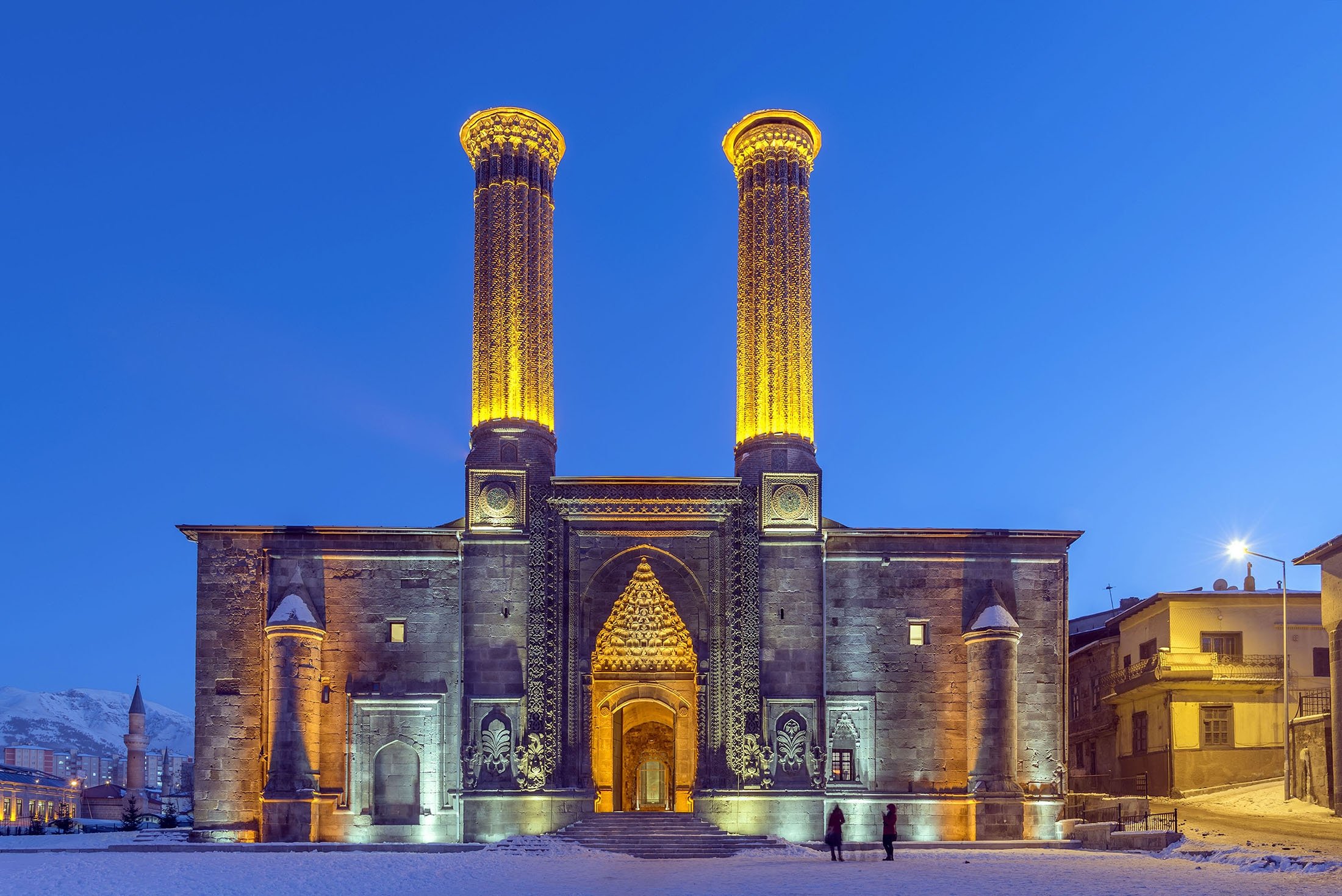 Lighting illuminates the Çifte Minareli Medrese (Double Minaret Madrasa) in the evening, in Erzurum, Turkey. (Shutterstock Photo)