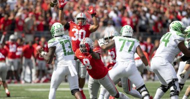 Quarterback Anthony Brown #13 of the Oregon Ducks throws a pass as defensive end Javontae Jean-Baptiste #8 of the Ohio State Buckeyes lunges to block him at Ohio Stadium, Columbus, Ohio, U.S., Sept. 11, 2021. (AFP Photo)