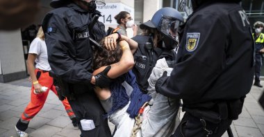Riot police carry away a demonstrator during a protest against the International Motor Show (IAA) in Munich, Germany, Sept. 10, 2021. (EPA Photo)