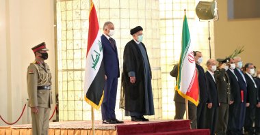 A handout picture provided by the Iranian presidency on September 12, 2021, shows President Ebrahim Raisi (C) receiving Iraqi Prime Minister Mustafa Al-Kadhemi (L) in the capital Tehran. (AFP Photo/HO/Iranian Presidency)