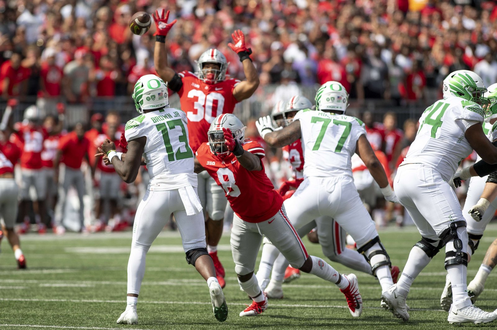 Quarterback Anthony Brown #13 of the Oregon Ducks throws a pass as defensive end Javontae Jean-Baptiste #8 of the Ohio State Buckeyes lunges to block him at Ohio Stadium, Columbus, Ohio, U.S., Sept. 11, 2021. (AFP Photo)