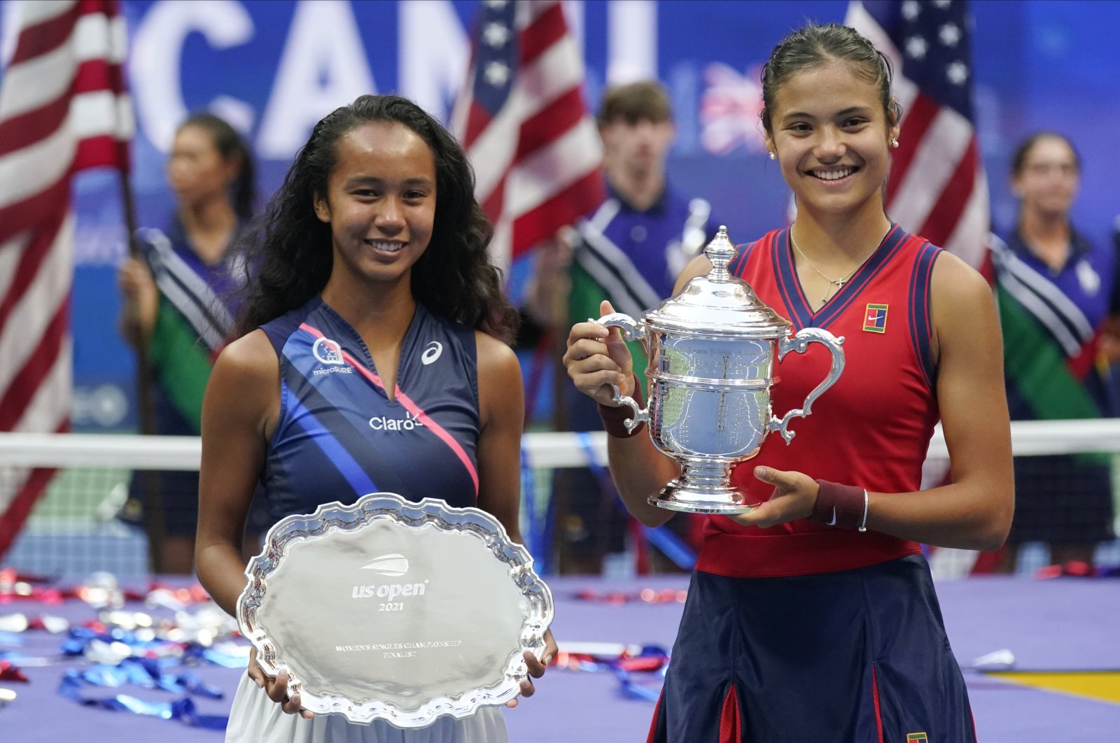 Leylah Fernandez, of Canada, left, and Emma Raducanu, of Britain, pose for photos after Raducanu defeated Fernandez in the women's singles final of the US Open tennis championships, Saturday, Sept. 11, 2021, in New York. (AP Photo/Seth Wenig)