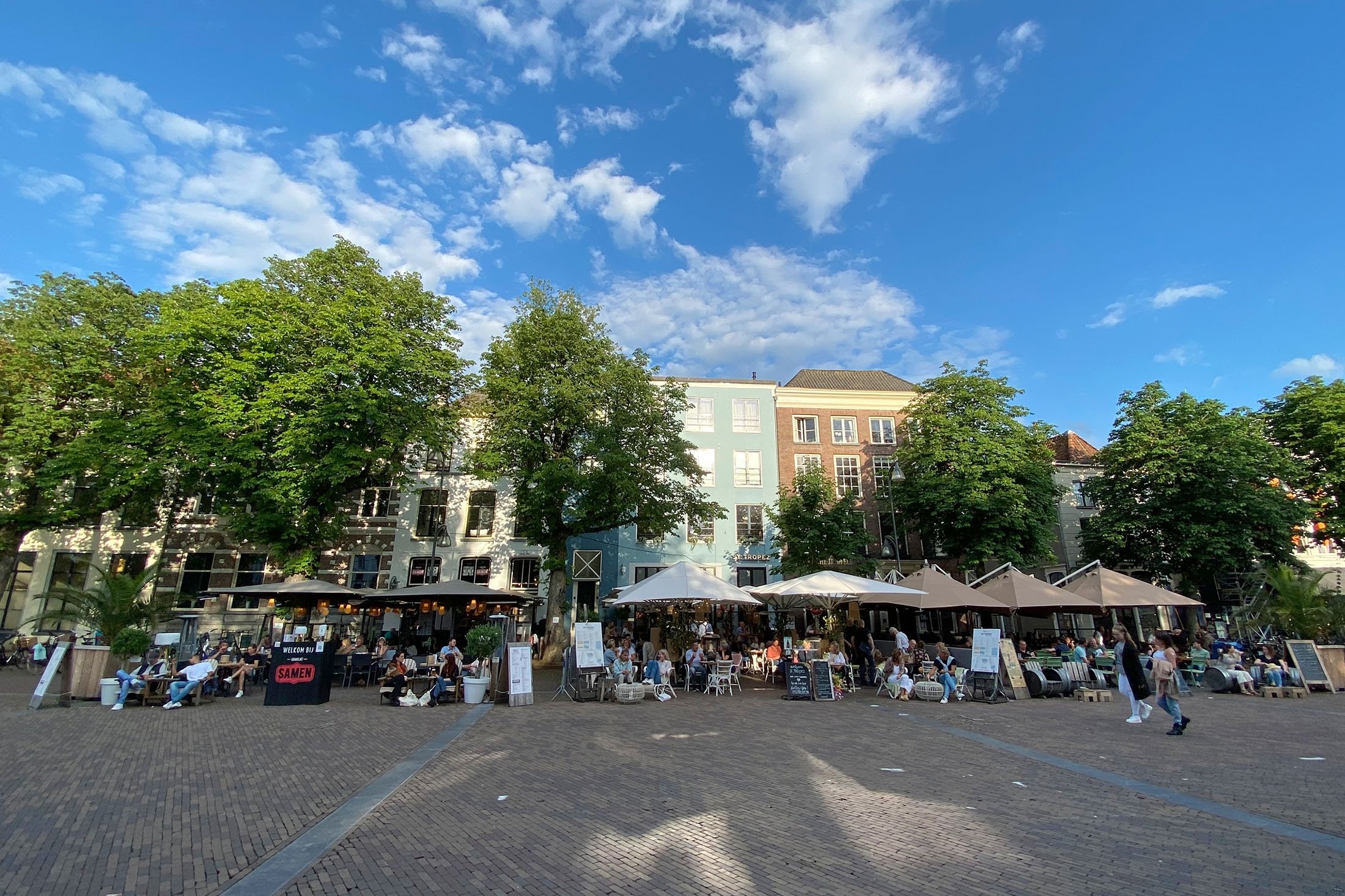 Outside dining areas on the central square of Deventer fill up with people having a good time when the weather