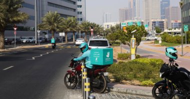 A delivery driver for the app Deliveroo prepares to make a delivery, in Dubai, United Arab Emirates, Sept. 9, 2021. (AP Photo)