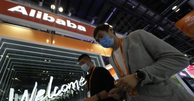 Visitors pass by the Alibaba booth during the China International Fair for Trade in Services (CIFTIS) in Beijing, China, Sept. 7, 2021. (AP Photo)