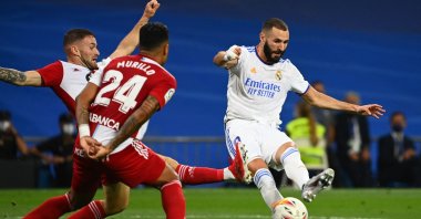 Celta Vigo's Spanish defender Javi Galan (L) challenges Real Madrid's French forward Karim Benzema during a La Liga match at the Santiago Bernabeu, Madrid, Spain, Sept. 12, 2021. (AFP Photo)