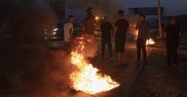 Protesters set tires on fire during clashes with Israeli troops following a demonstration supporting Palestinian prisoners in Israeli jails, at the entrance of the West Bank city of Nablus, Palestine, Monday, Sept. 13, 2021. (AP Photo)