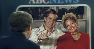 This image released by Searhlight Pictures shows Andrew Garfield as Jim Bakker (C) and Jessica Chastain as Tammy Faye Bakker in a scene from "The Eyes of Tammy Faye." (AP Photo)